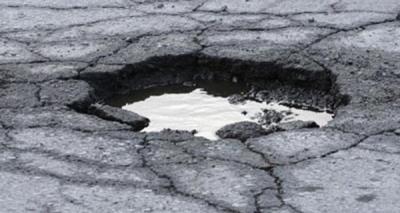 Large pothole in the ground